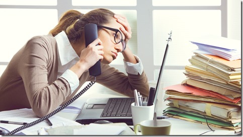 a-stressed-business-woman-looks-tired-she-answer-telephones-in-her-office